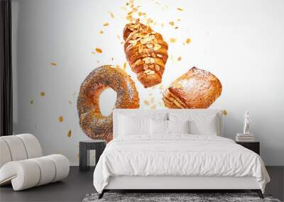 Croissant bun brioche cake flying in air. Fresh baked puff pastry cookie falling on white. Delicious french baking croissant with almond. Levitation, fly bread bakery products cafe concept Wall mural