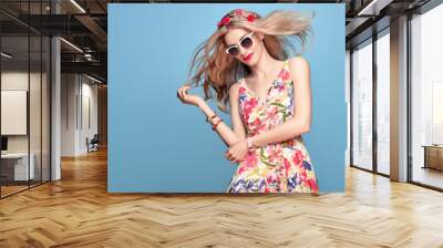 Fashion Beauty. Sensual Sexy Blond Model in fashion pose Smiling. Woman in Summer Outfit. Trendy Floral Dress, Stylish wavy hairstyle, fashion Flower Pink Hairband. Playful Happy Romantic summer Girl Wall mural