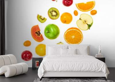 Fresh fruits flying in air. Papaya, apple, orange, kiwi, melon, citrus isolated on white. Fruity vegan tropical mix background. Colorful levitation, falling fly fruit creative concept Wall mural