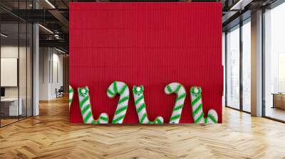 Hand painted Christmas gingerbread green and white candy cane and snowflakes on a beautiful red background. Card concept. Top view. Flat lay. Wall mural