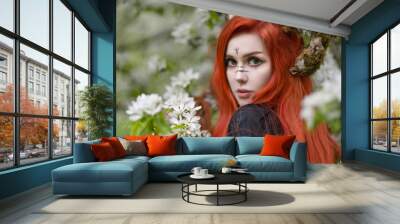 Close-up portrait of a red-haired witch with moss-covered horns Wall mural