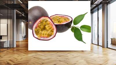 Purple passion fruit and two halves with ripe yellow flesh with green leaves on a neutral white background Wall mural