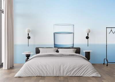 Crystal clean drink water in transparent glass on light blue background. Copy space. Minimalism. Wall mural