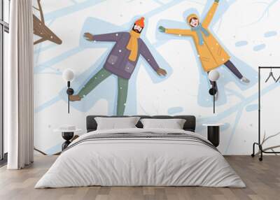 Happy couple of young people making snow angel in snow. Wall mural