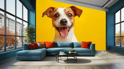 Portrait of a cute smiling happy small dog Jack Russell terrier on a yellow background isolated. Dog close up on color background. Concept pets love, animal life, humor. Wall mural