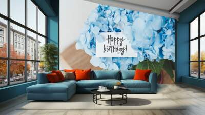 beautiful bouquet of blue hydrangea in a vase and a white card with the inscription Happy birthday Wall mural