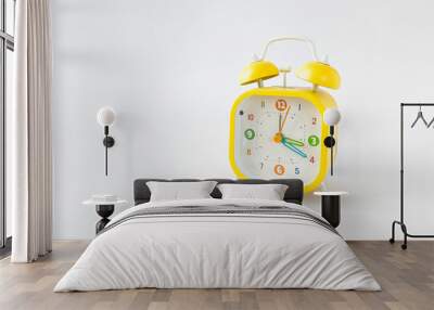 horizontal photo of bright yellow alarm clock with on white background, copyspace Wall mural