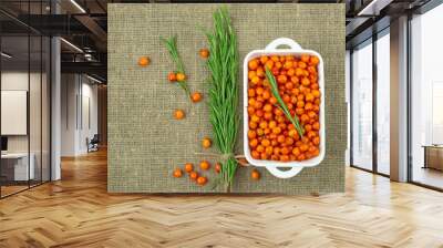 Sea buckthorn berries and rosemary herb on canvas cloth .Beautiful food photo .Natural background Wall mural