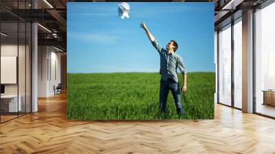 man throws the paper in the field Wall mural