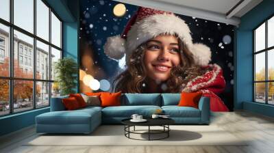 Portrait of a beautiful smiling young woman wearing a Santa Claus hat on a bright festive blurred background with bright bokeh and snowflakes. Wall mural