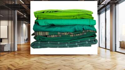 Stack green winter clothes isolated on white background Wall mural