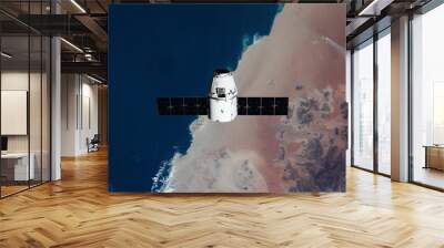 The SpaceX Dragon resupply ship is pictured approaching the International Space Station. Elements of this image furnished by NASA Wall mural