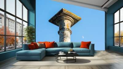 concept of antique architecture, top of ancient mossy column against sky background Wall mural