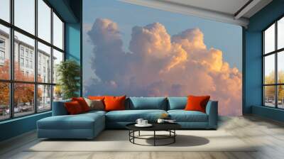 Beautiful colored dramatic cumulus fluffy clouds on blue sky at sunset Wall mural