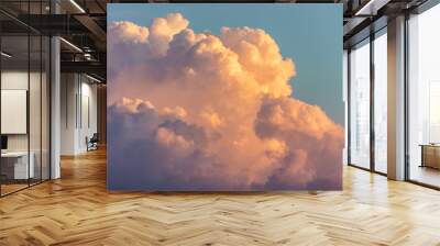 Close up view of beautiful colored dramatic cumulus fluffy clouds on blue sky at sunset background Wall mural