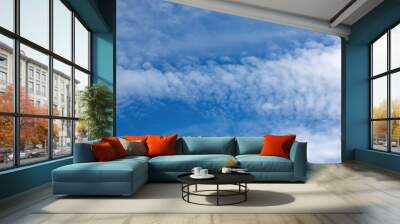 white clouds in bright blue sky Wall mural