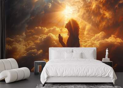 a man kneels and prays, hands folded and raised, and a ray of light falls from the sky
 Wall mural