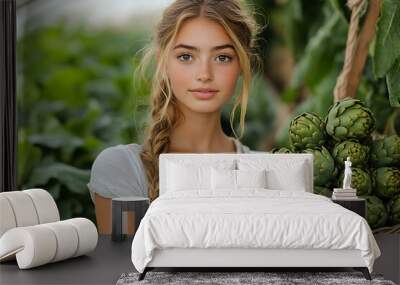 Photo of a cute girl standing in a garden, holding a wicker basket filled with artichokes. Greenery and fresh vegetables create a natural, rural atmosphere.
 Wall mural