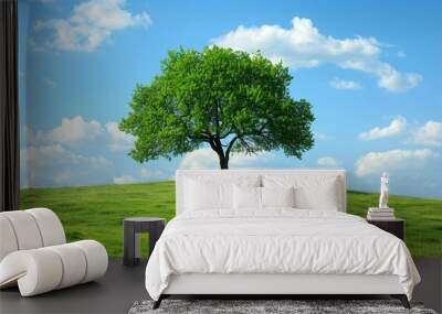 Green tree on the grassy hill under blue sky with white clouds,beautiful landscape wallpaper. Wall mural