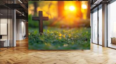 Wooden cross stands on grass in field,copy space,banner,symbolizing Jesus' death and resurrection. Wall mural