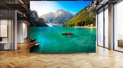 amazing view of braies lake with wooden boats on the water, surrounded by dolomites mountains. Trentino alto adige, Italy Wall mural