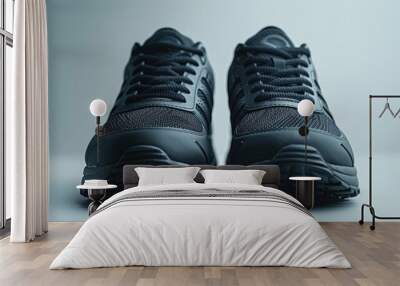 close-up front view of black sneakers on a white surface. Wall mural