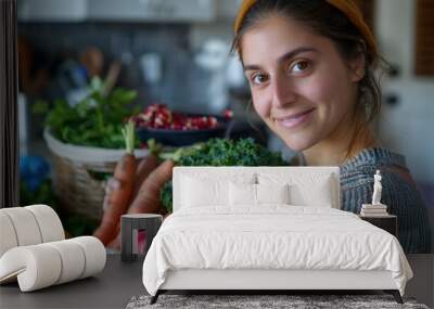 Happy Young Woman Holding Fresh Vegetables in Kitchen Wall mural