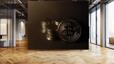 Golden Bitcoin and Rupiah coin isolated on black background. Cryptocurrency and Indonesian currency Wall mural