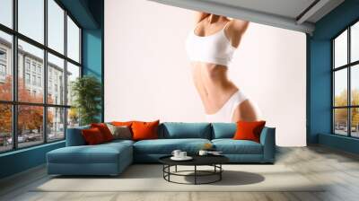 Close up shot of unrecognizable fit woman in lingerie isolated on white background. Torso of slim attractive female with flat belly in white underwear. Copy space for text. Wall mural