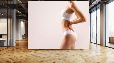 Cropped image of a sporty female in white bra and panties. Wall mural