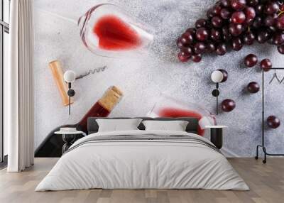 Flat lay composition with two glasses of vintage red wine, bunch of grapes & corkscrew on grunged concrete table background. Expensive bottle of cabernet sauvignon concept. Copy space, top view. Wall mural