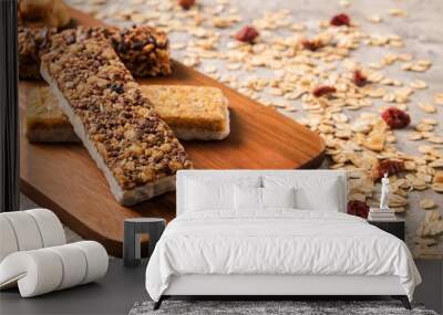 Mixed gluten free granola cereal energy bar with dried fruit & various nuts, gray concrete background. Healthy vegan super food, fitness dieting snack for sporty lifestyle. Top view, copy space. Wall mural