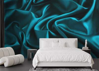 Close up of ripples in turquoise silk fabric. Satin textile background. Wall mural