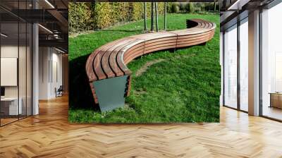 A modern bench  in a city park on a sunny day Wall mural