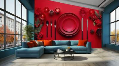 A beautifully arranged holiday table features red plates, candles, and festive decorations, setting the perfect mood for a seasonal gathering Wall mural