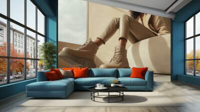 A model models fashionable beige platform boots paired with stylish clothing, seated in a contemporary room filled with natural light. The overall aesthetic is chic and modern Wall mural