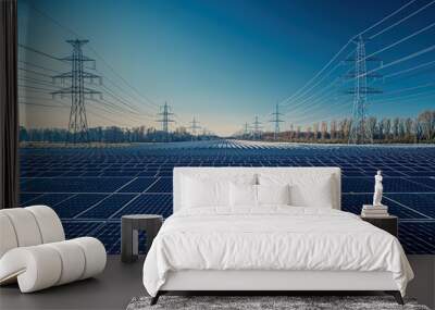 A sprawling field of solar panels collects sunlight as power lines stand tall in the background, emphasizing the transition to renewable energy sources during the afternoon Wall mural