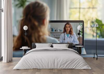 A woman engages in a virtual consultation with a doctor, sitting comfortably on her couch with sunlight streaming in through the window Wall mural