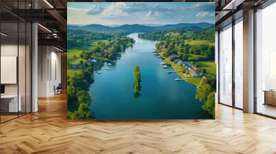 The calm river flows gently between trees and hills, dotted with small boats and vibrant green landscapes on a sunny day Wall mural