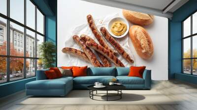 Appetizing sausages and bread placed on white table Wall mural