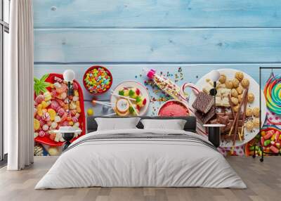 Assorted colourful party sweets with copy space Wall mural