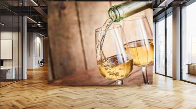 Dispensing golden white wine into two wineglasses Wall mural