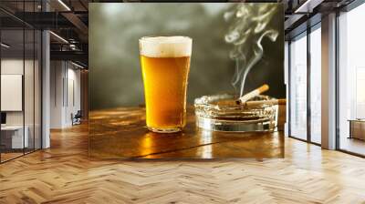 ice cold lager or beer with a burning cigarette Wall mural