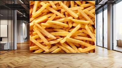 Overhead view of golden deep fried French fries food in full frame closeup. Wall mural