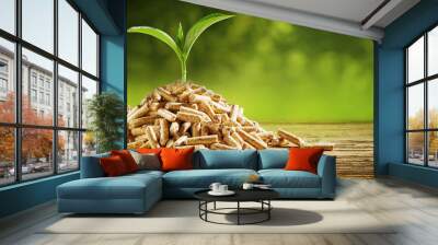 Seedling sprouting from a pile of wood pellets Wall mural