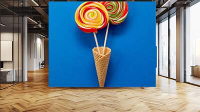 Two colorful spiral lollipops in ice cream cornets Wall mural