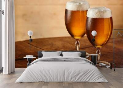 Two stemmed glasses of fresh draft or craft beer Wall mural