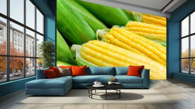 Fresh ripe corn in street market, close-up. Peeled ears of sweet corn with yellow grains. Organic food. Wall mural