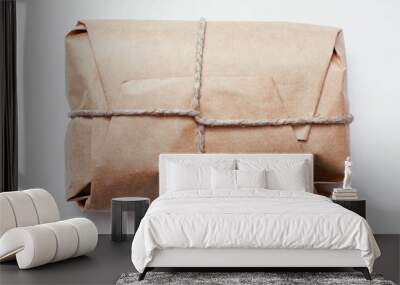 Box parcel wrapped in brown craft paper   tied hemp cord on white background.  Wall mural