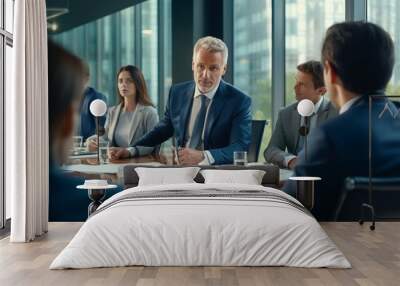 A group of people are sitting around a table in a conference room Wall mural